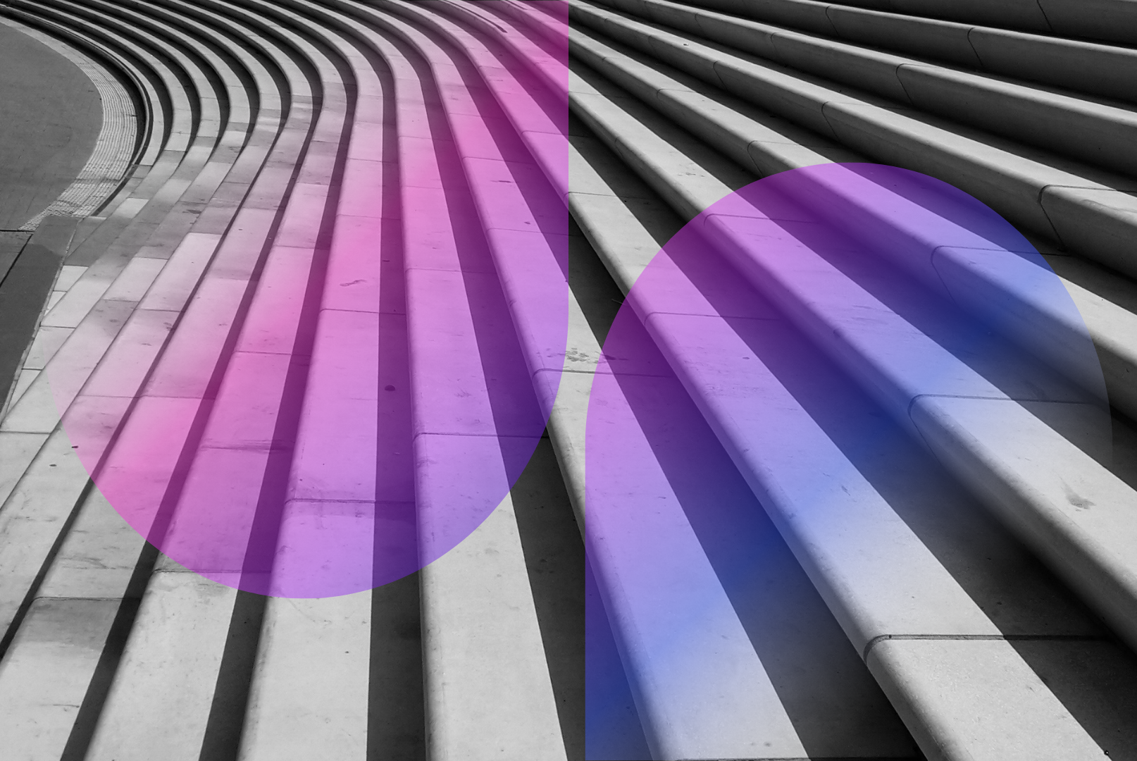 Curved stone steps with two translucent geometric shapes overlayed: a pink shape on the left side and a blue shape on the right, creating colorful shadows on the monochrome staircase.