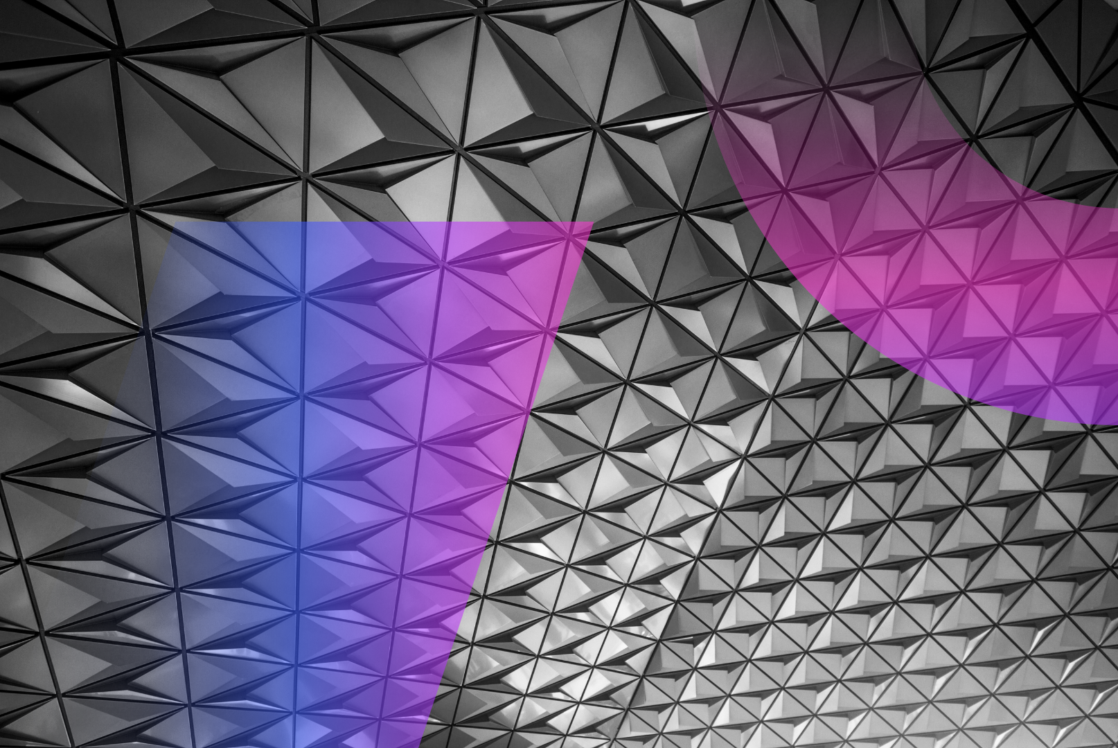 Geometric ceiling with a repeating triangular pattern in grayscale, overlaid with a semi-transparent pink arc and a blue-purple translucent shape, creating a modern abstract design.